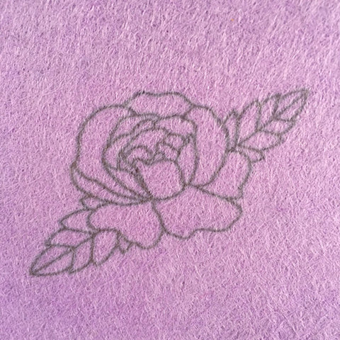Lazy May Iron on rose embroidery transfer applied to light purple wool felt