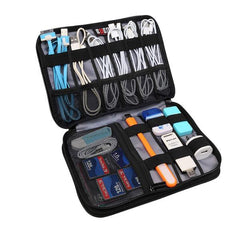 Black travel electronics organizer showcasing the many compartments to house cables, cords, and electronics. Best travel organizer by plentiful travel, travel products.