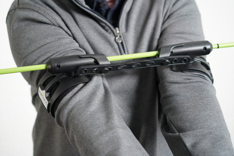 close up illustration of swing align golf swing training aid on a man's forarms