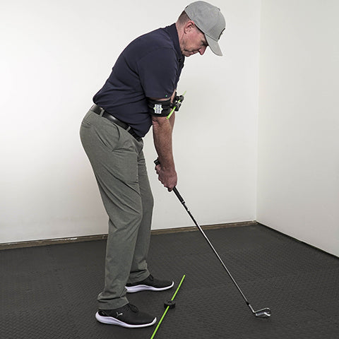 a man setting up for a perfect golf swing