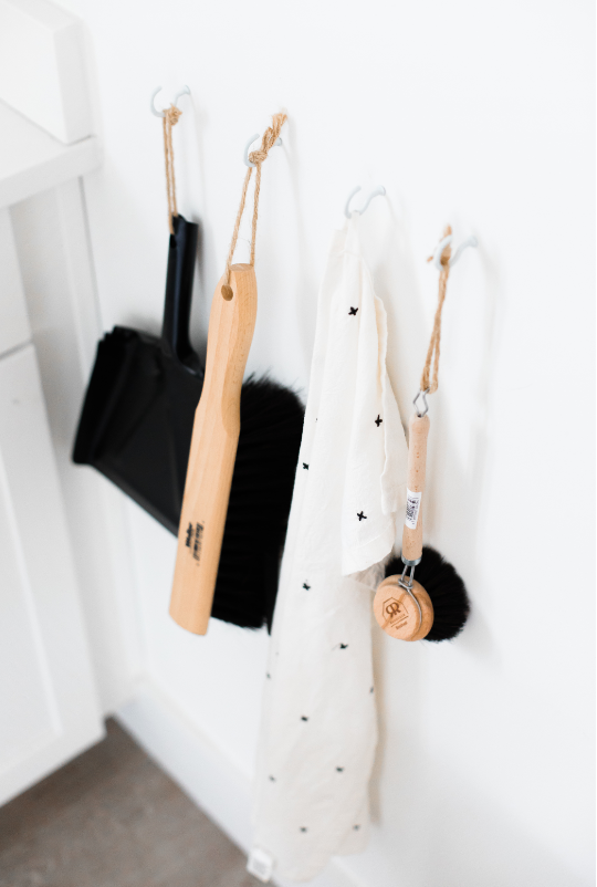 Hanging house cleaning tools in a clean home
