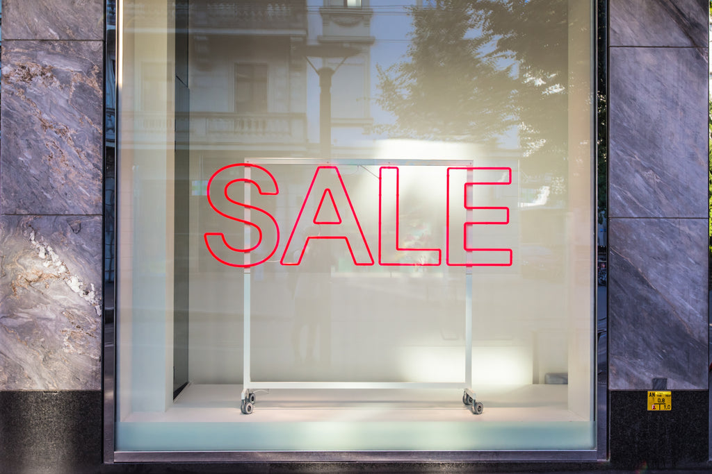 SALE sign on an empty shop display window