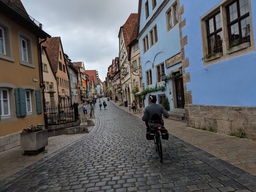 Photo of Jim riding his Cruzbike Q45 adventure touring recumbent bike on medieval cobblestone streets in Bavaria 