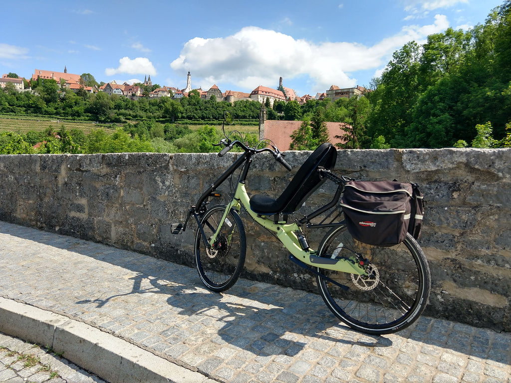 Photo of Cruzbike Q45 adventure touring recumbent bike with Bavarian village in the background on a beautiful day