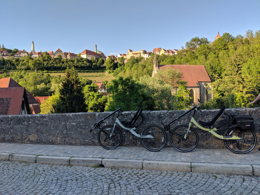 Photo of Jim and Maria's Cruzbike Q45 touring recumbent bikes on an old stone bridge overlooking the city