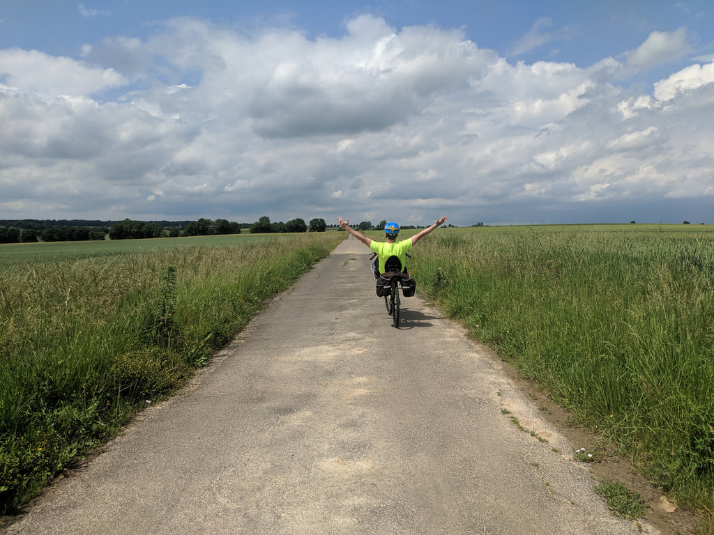 Photo of Jim cycling with no hands on a beautiful path in the Bavarian countryside