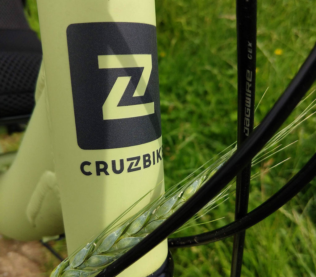 Cruzbike Q45 headbadge next to green wheat in german fields.