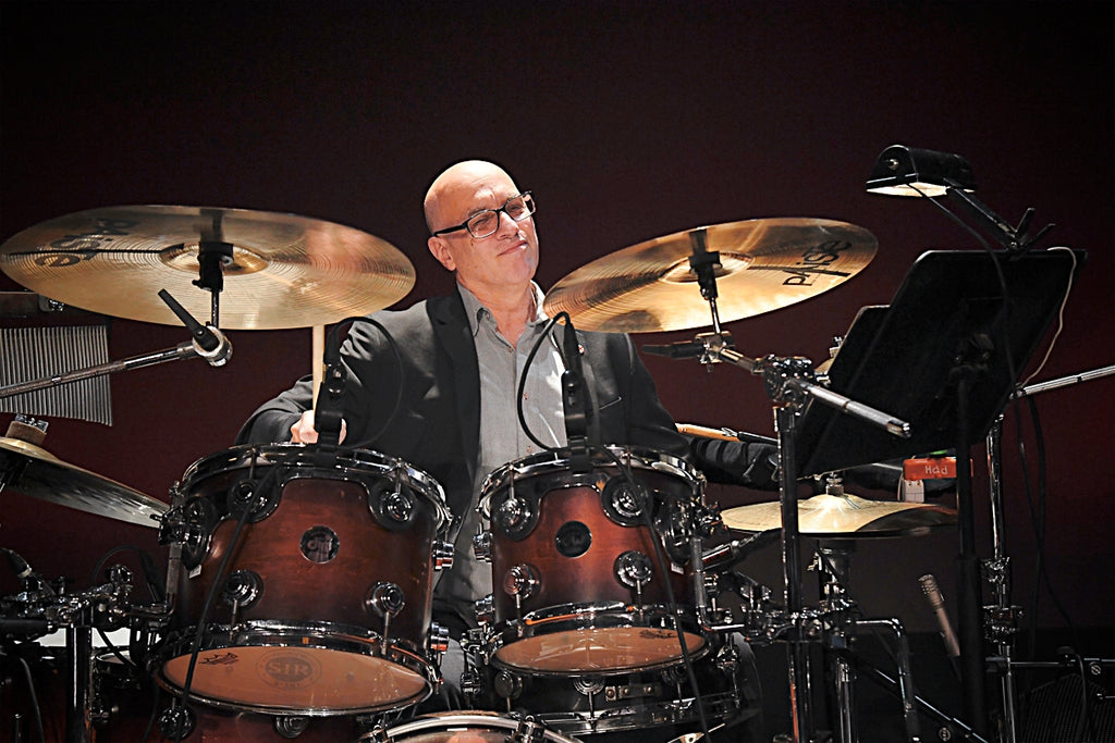 Photo of Jon Berger behind a drumset.