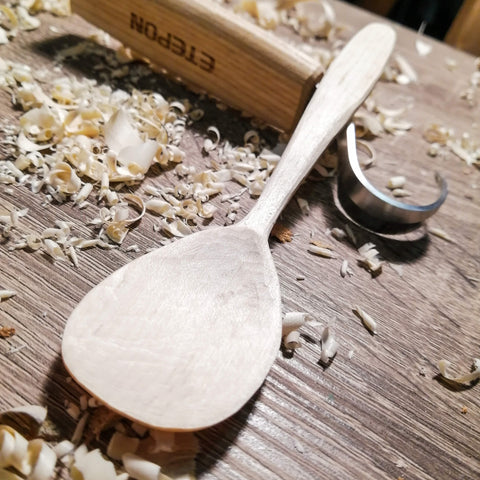 hand carved spoon with just two cheap knives