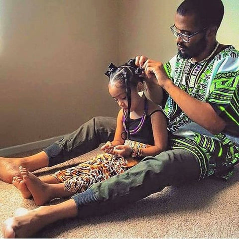 Dad doing daughter's hair