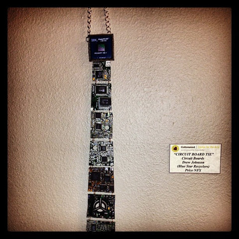 The first Real Circuit Board Tie hanging in the art show. A sign naming Drew Johnson with Blue Star Recyclers is beside the tie. Priced NOT FOR SALE.