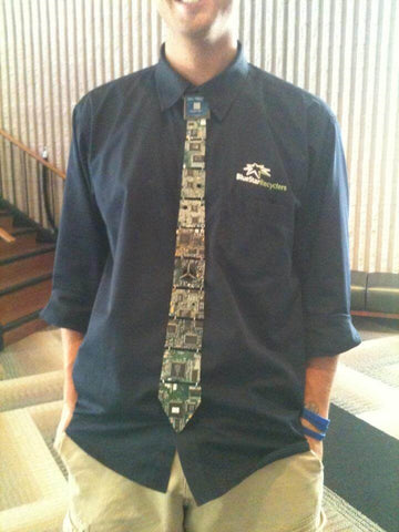 Drew smiling in his Blue Star Recycling work shirt, wearing the very first Real Circuit board Tie ever created.