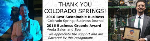 Drew is holding the 2016 business Greenie award and the 2016 best sustainable business award. 