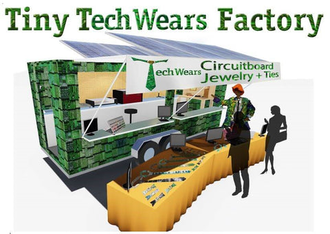 A mock up of what the Tiny Techwears Factory would look like. A trailer covered in circuit board shingles, with fold out windows similar to a food truck, solar pannels on the roof, tables out front displaying product.