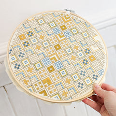 Aurifil artisan Cross stitch in hoop by Lucy Engels