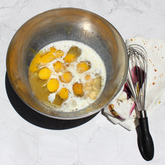 Eggs in bowl with salt and spices (before whisking)