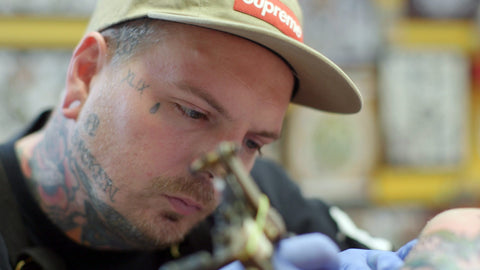 Billy White, a tattoo artist and owner of the Red Rose Tattoo shop, as he's tattoing