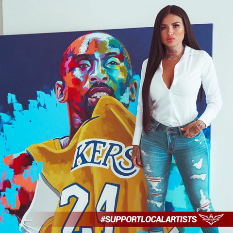 Artist and model, known as "Tatu Baby" standing in front of her mural painting of Kobe Bryant