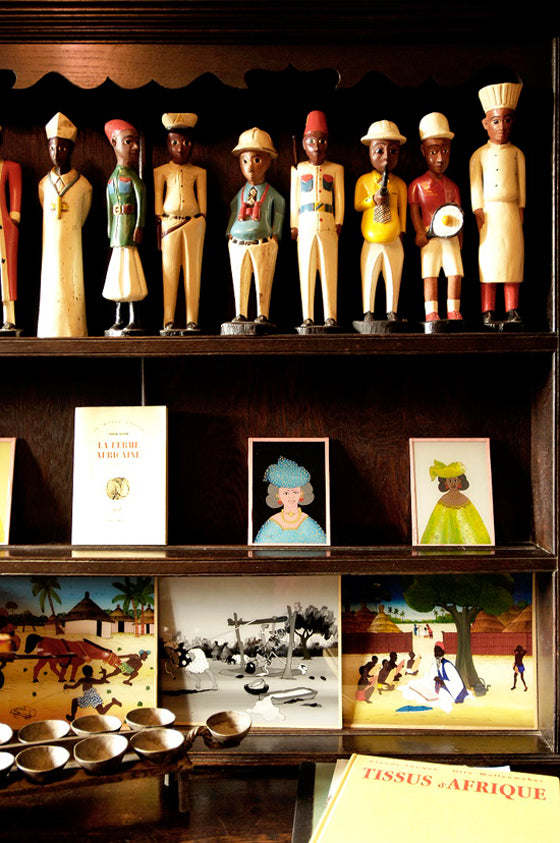 Quirky colonial men | A beautiful book shelf collection of West African Colon statues