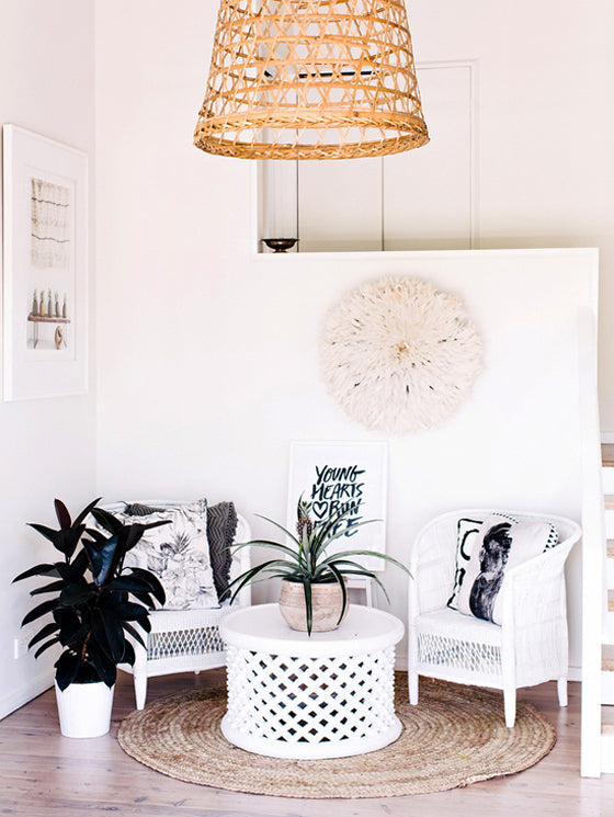 White on white | Lovely seating nook featuring a White Bamileke Feather Headdress [Juju hat] and a Bamileke Stool + Table