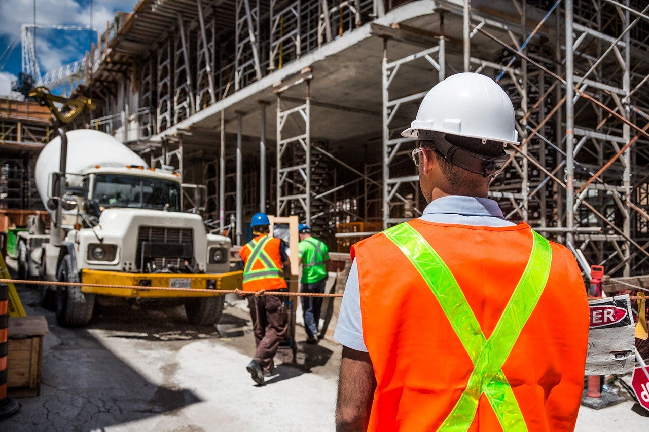 man wearing protective equipment looking towards the workers position