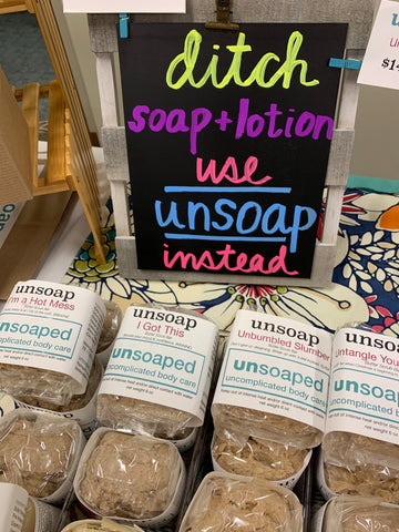 unsoap butter scrub bars, packaged and displayed for sale at an event