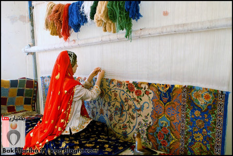 An artisan working on a hand knotted rug