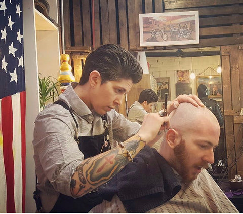 Barber Trish shaving a customer's head at PRKCHPS in Atlanta, Georgia