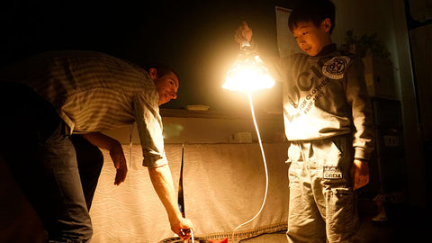 kids upcycling plastic bottles and paper into lamps in a workshop by ecoBirdy