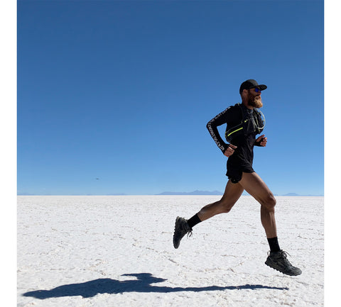 Tommy Rivs running in desert 