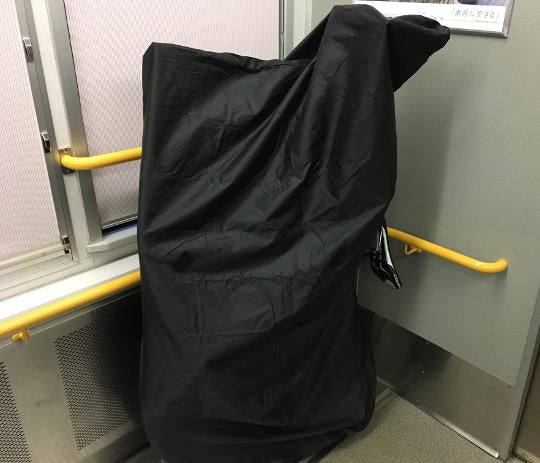 The bike in the bike bag in the extra space section of a local train in Osaka.