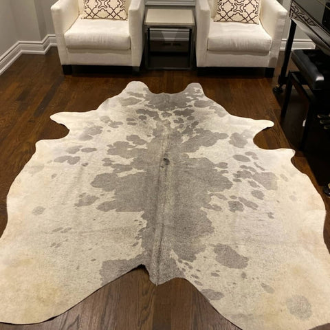 large white cowhide rug Chincoteague Virginia is mix of spotted grey white and can be added to hallway in your grey house during Victorian renovation process.