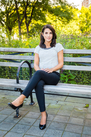 cancer survivor, Vanessa Steil sitting on bench at park