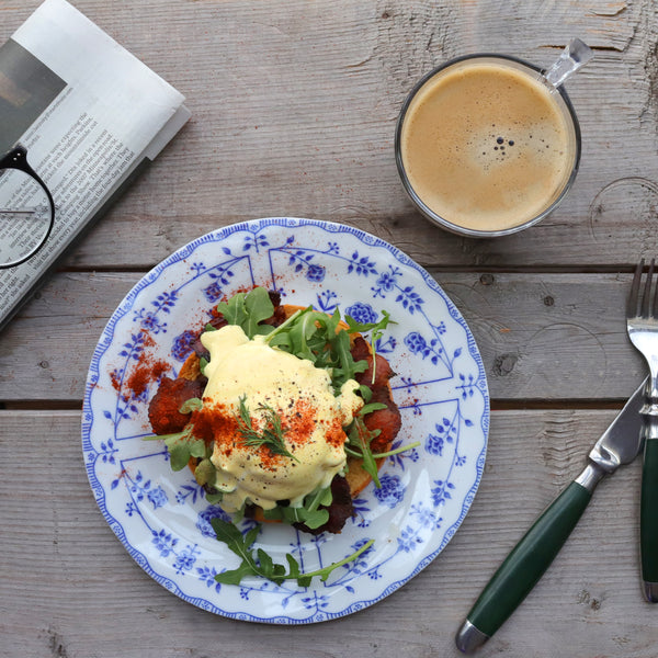 Daily Kneads Bagel Hollandaise with Eggs Benedict Recipe on Blue Plate with Coffee