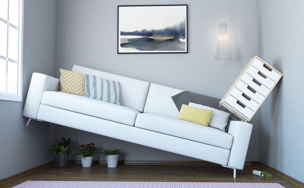 Large sofa crammed into a narrow room on an angle, "How to Make A Narrow Room Look Wider", from Estilo Living Blog