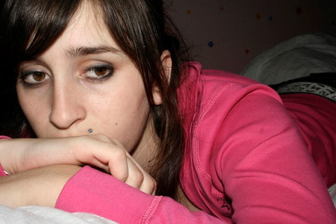 Depressed girl on bed