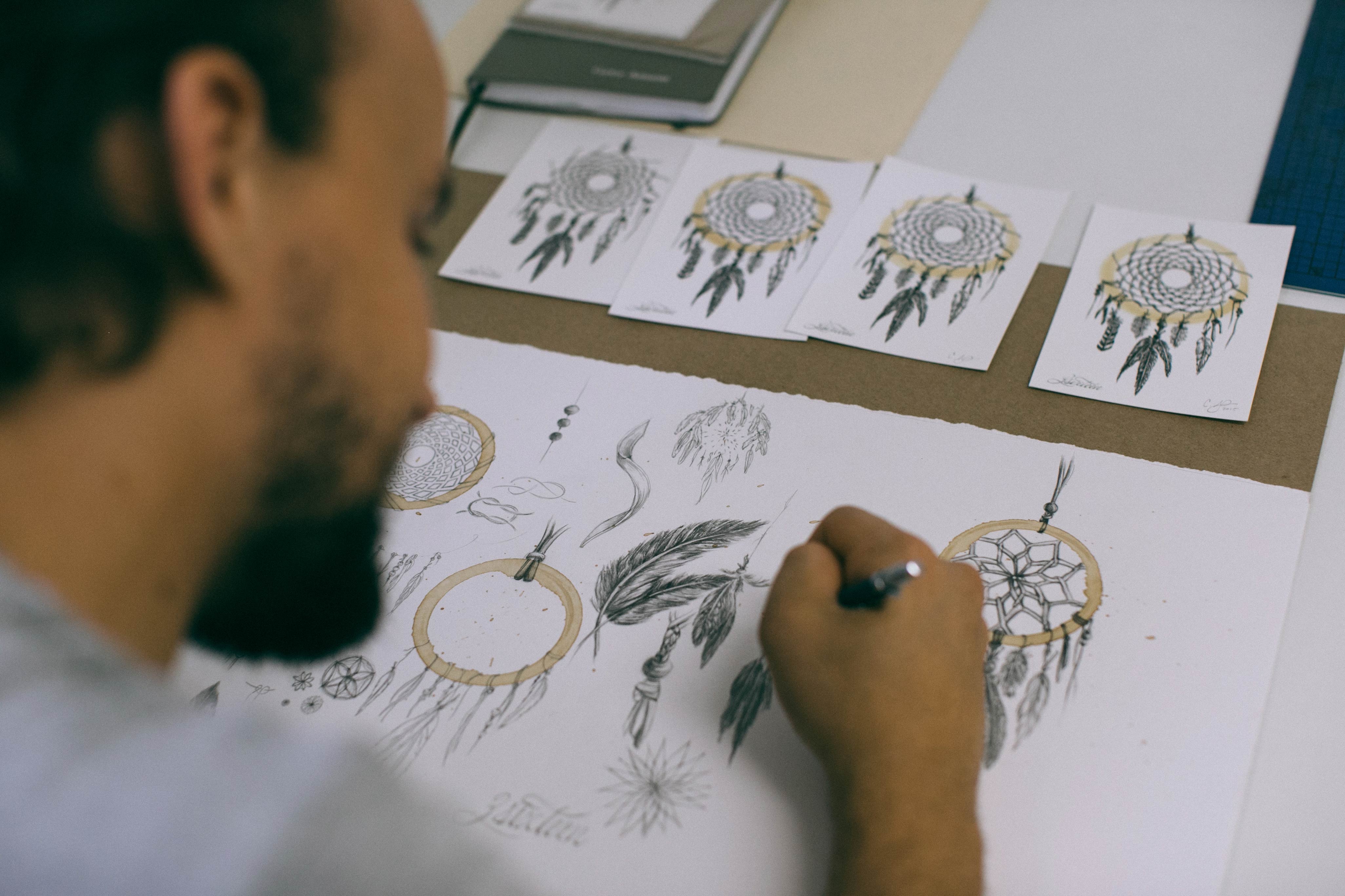 Photo of Carter working on his coffee-stain dreamcatcher series.