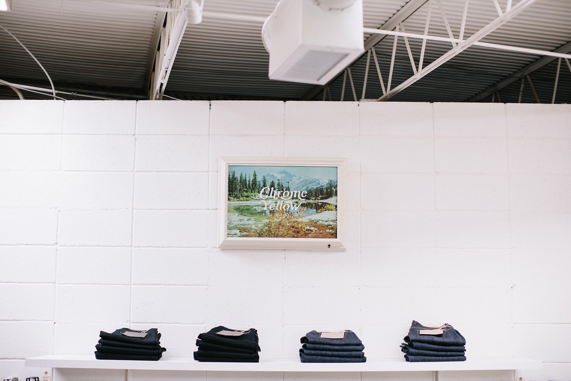 Jeans displayed on shelf.