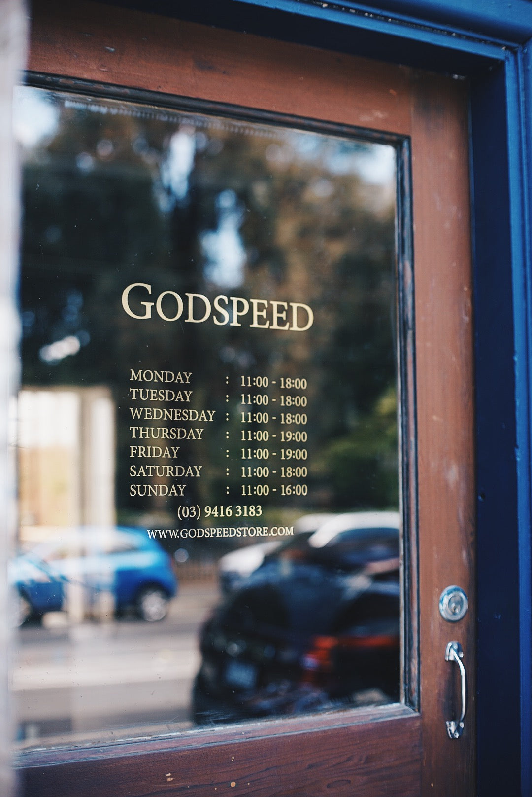 Close up view of shop hours on glass.