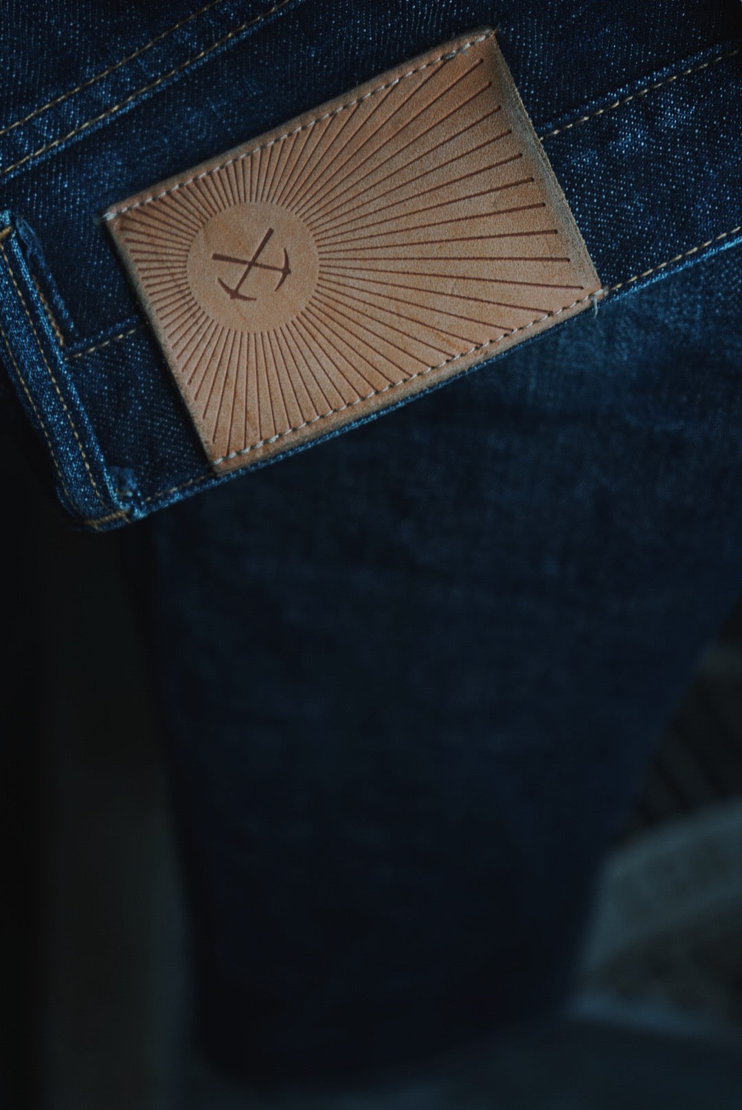 Close up view of leather patch on jean.
