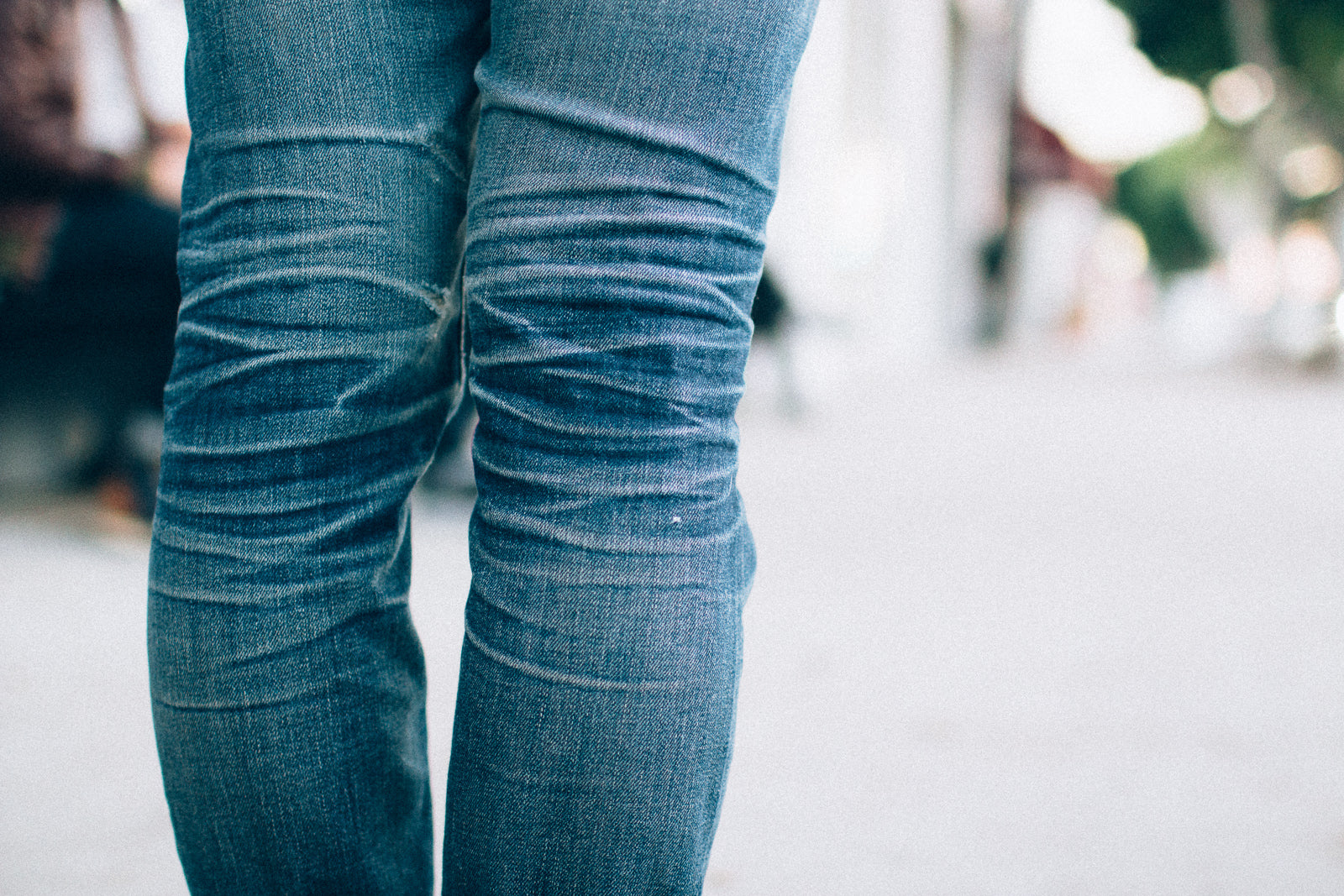 Faded whiskers of jeans.