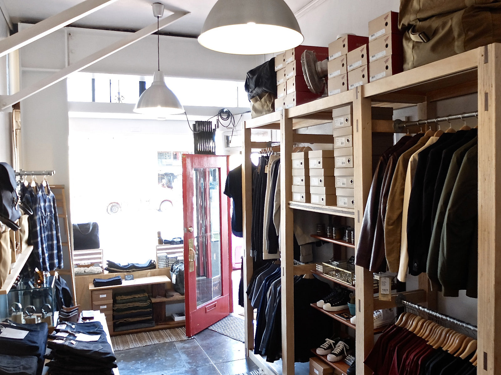 Internal shot of Snake Oil Provisions showing clothing on racks and the front door