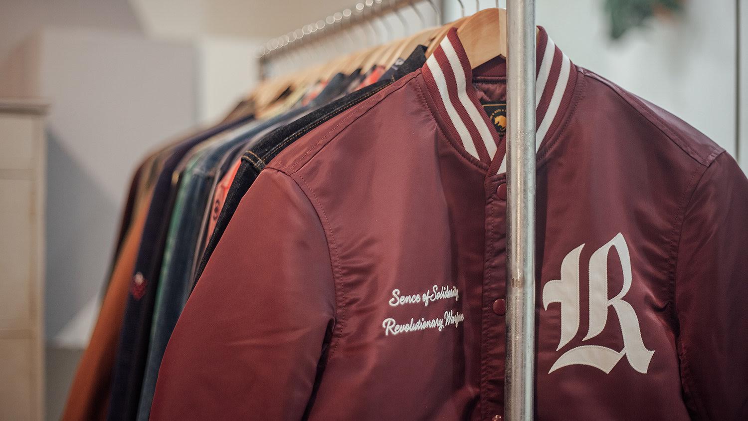 Jackets hanging on rack.