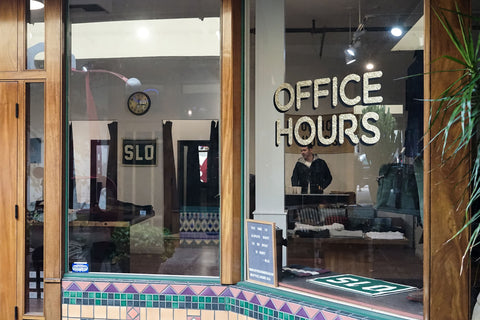 The storefront features brightly covered tiles, natural wood framing the windows and the Office Hours logo in gold leaf text.