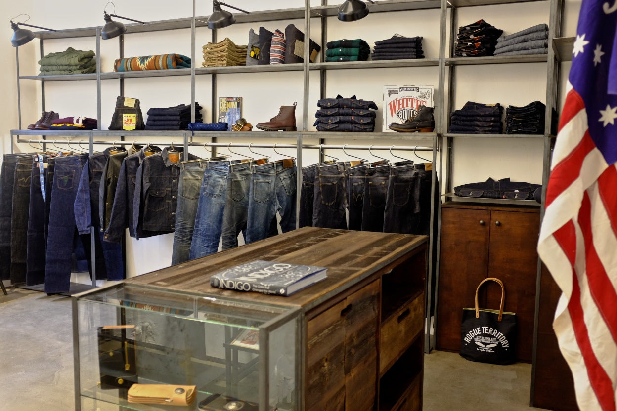 Display rack showcasing an assortment of denim and leather goods.