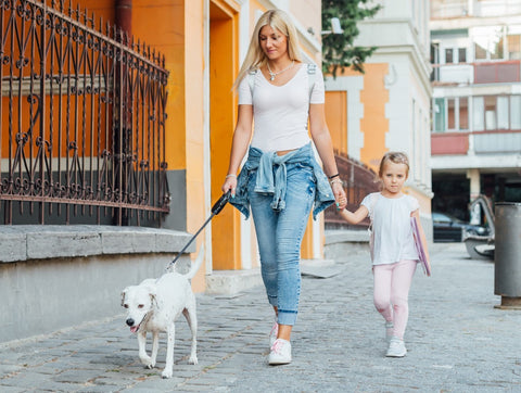 mother-walking-girl-to-school-with-dog