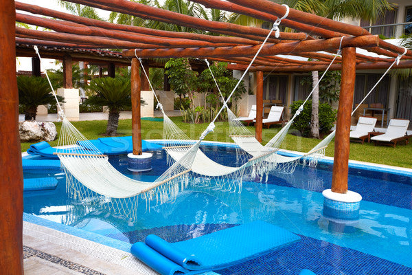 Hammocks hung over swimming pool