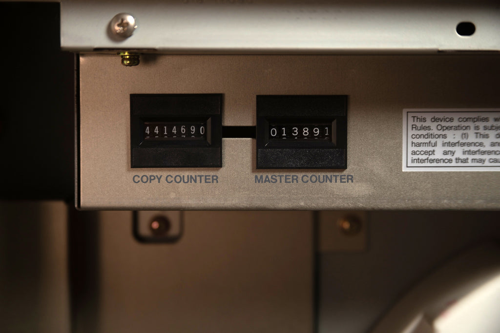 Photograph of the Diskette Press Risograph's copy counter and master counter. The machine has made over 4.4 million copies, and over 13 thousand masters.