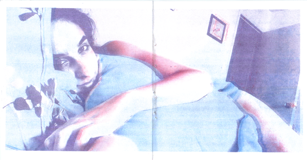 Image showing the final composite image of three colors printed over one another. The final image depicts Carta Monir on a bed, looking at the viewer and wrapping herself around a pillow.