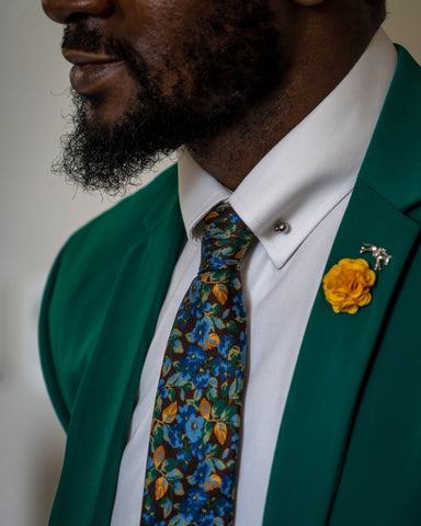 man in green blazer and floral tie